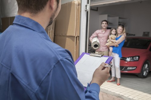 Packed moving boxes and furniture ready for transport in West London