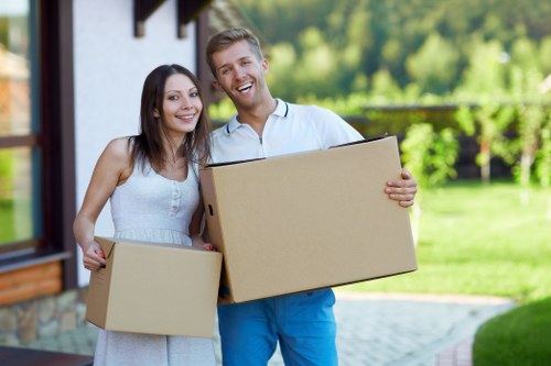 Packed moving boxes and protected furniture ready for a West London house move