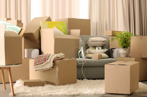 Packed moving boxes and furniture ready for removal services in a Maida Vale home