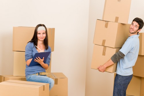 Movers navigating stairs in a period property during a Maida Vale house move